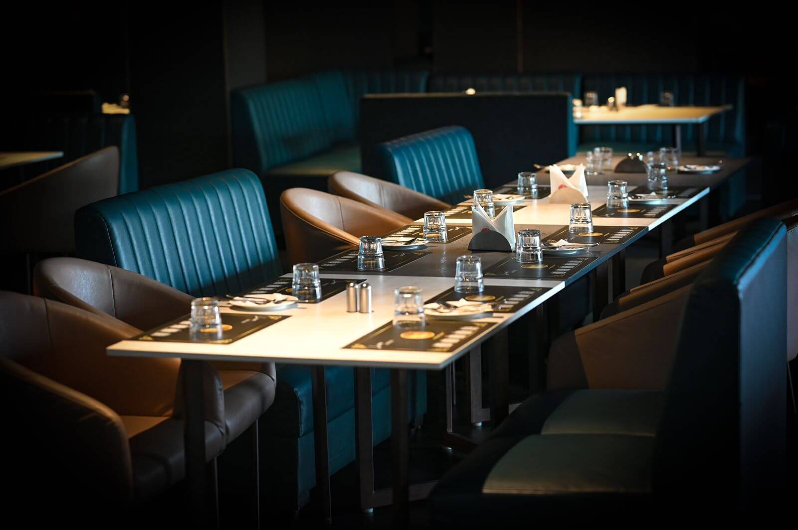 Booth seating laid for dinner at Imperial Kitchen